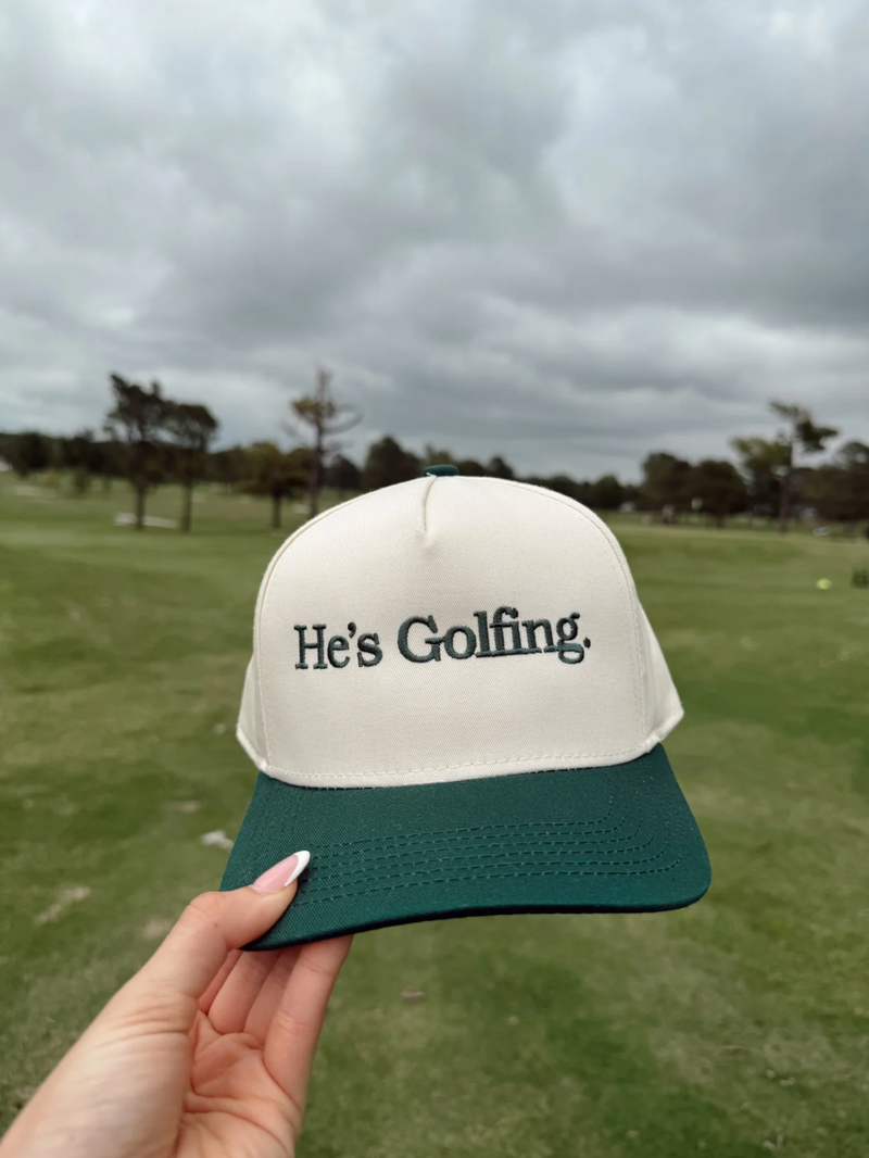 He's Golfing Trucker Hat